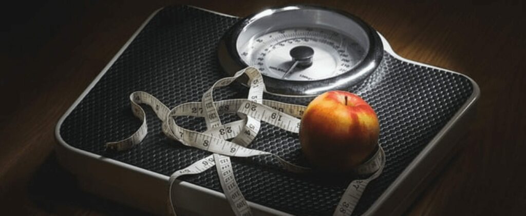 scale with a ruler and apple on it
